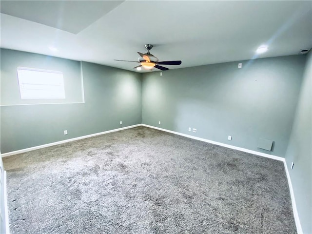 carpeted spare room featuring ceiling fan