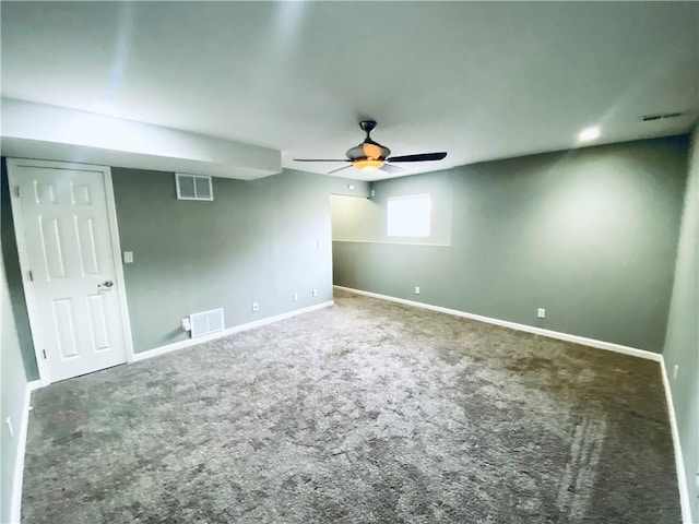 basement with ceiling fan and carpet flooring