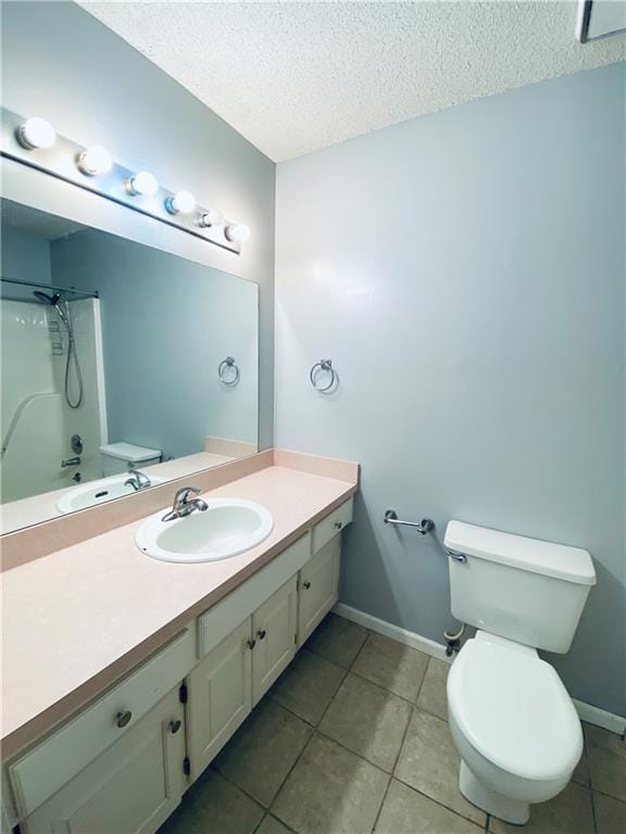 bathroom with vanity, a textured ceiling, toilet, and tile patterned floors