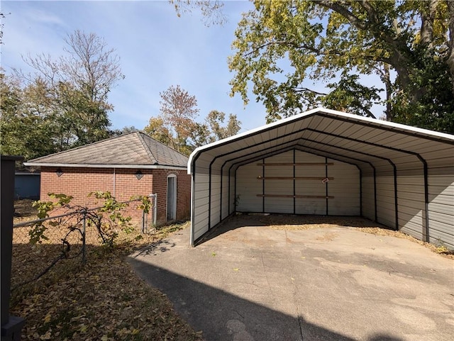 612 W Cherry St, Nevada, MO 64772 - garage featuring a detached carport and fence