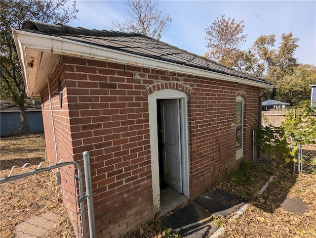 612 W Cherry St, Nevada, MO 64772 - view of home's exterior with brick siding and fence