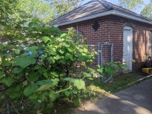 612 W Cherry St, Nevada, MO 64772 - view of side of home with brick siding