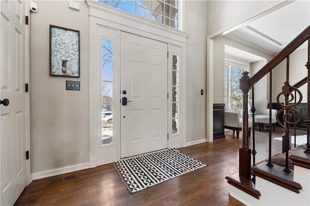 entryway with dark hardwood / wood-style flooring