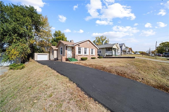 ranch-style home featuring a front lawn and a garage