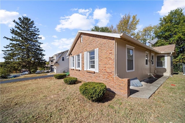 view of side of home featuring a yard