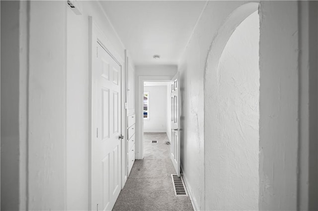 corridor with dark colored carpet