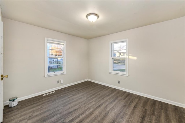 unfurnished room featuring dark wood-type flooring