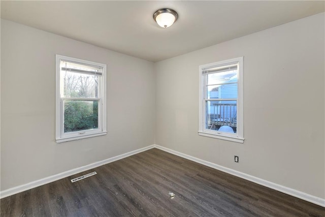 empty room featuring dark wood-type flooring