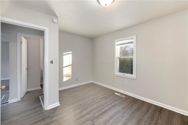 unfurnished bedroom with dark hardwood / wood-style flooring