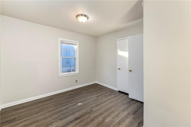 empty room with dark hardwood / wood-style floors