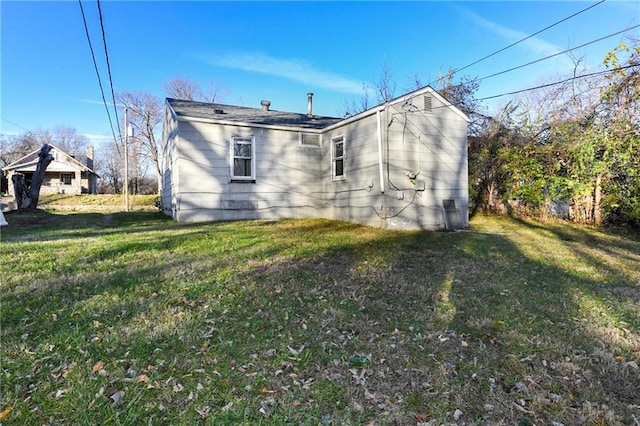 rear view of property with a yard