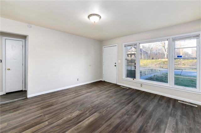 spare room featuring dark hardwood / wood-style floors