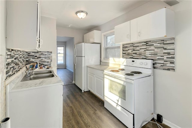 kitchen with white cabinets, a healthy amount of sunlight, and white appliances