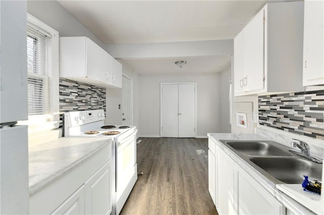 kitchen featuring white cabinetry, sink, dark hardwood / wood-style floors, white range with electric cooktop, and decorative backsplash