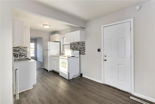 kitchen featuring decorative backsplash, sink, white cabinets, and white appliances