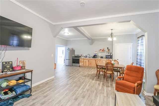 interior space featuring ornamental molding, a chandelier, appliances with stainless steel finishes, and light hardwood / wood-style flooring