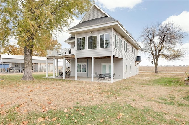 back of property featuring a patio, a deck, and a yard