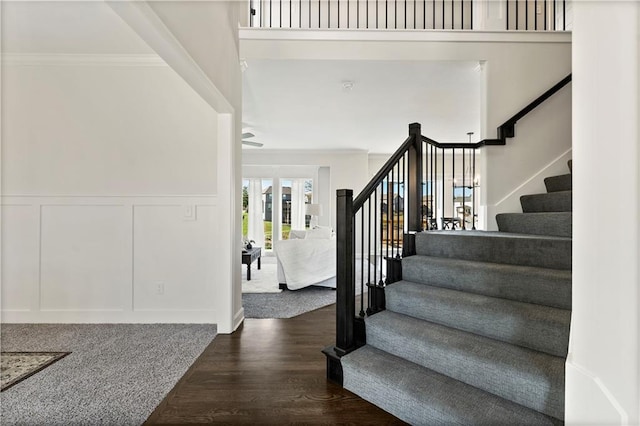 foyer with ornamental molding and wood-type flooring