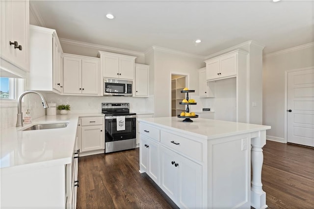 kitchen with sink, white cabinets, a center island, and stainless steel appliances