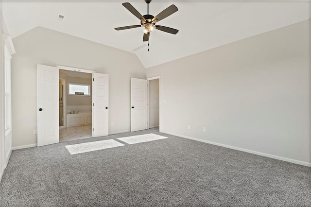 unfurnished bedroom with lofted ceiling, carpet floors, ensuite bath, and ceiling fan