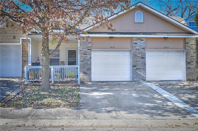 ranch-style home featuring a garage and covered porch