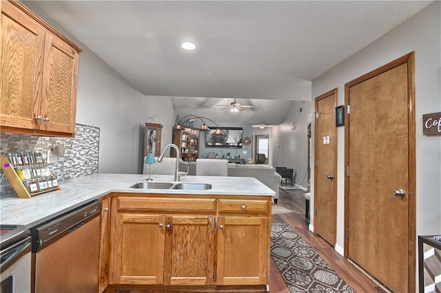 kitchen with kitchen peninsula, hardwood / wood-style flooring, sink, ceiling fan, and appliances with stainless steel finishes