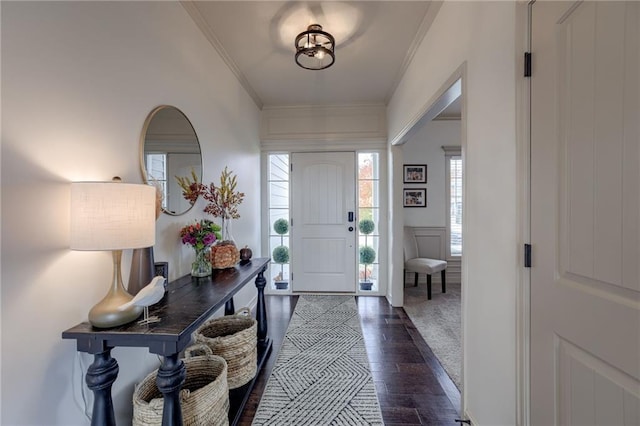 foyer entrance featuring dark hardwood / wood-style floors and crown molding