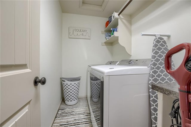 laundry room featuring light tile patterned floors and washer and clothes dryer