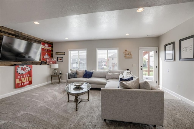 living room featuring plenty of natural light, carpet flooring, and a textured ceiling