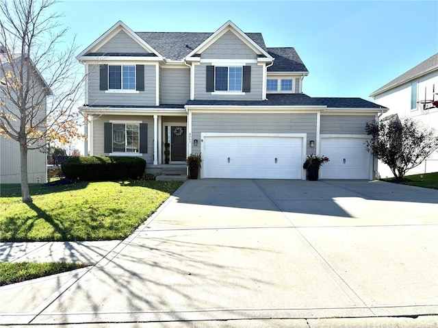 view of front of home with a garage and a front yard