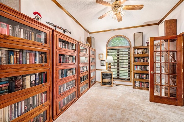 sitting room featuring a textured ceiling, carpet floors, ceiling fan, lofted ceiling, and ornamental molding