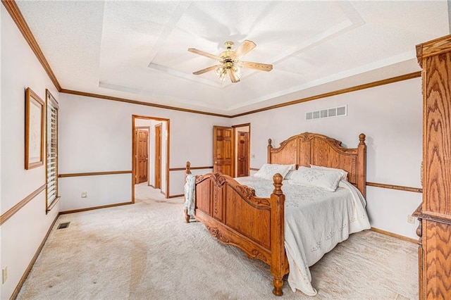 bedroom featuring ornamental molding, light colored carpet, a raised ceiling, a textured ceiling, and ceiling fan