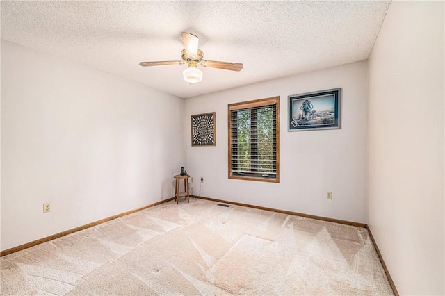 unfurnished room featuring carpet, ceiling fan, and a textured ceiling