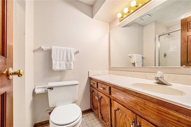 bathroom featuring a textured ceiling, a shower with shower door, toilet, vanity, and tile patterned flooring