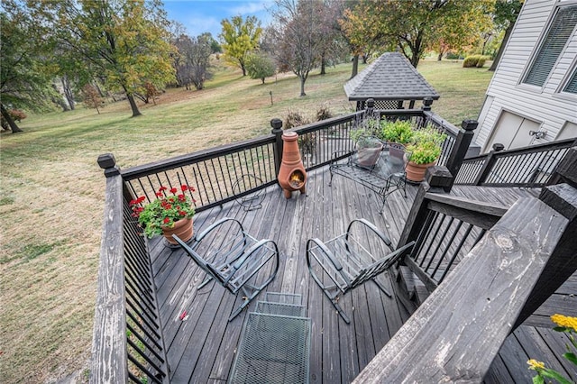 wooden deck featuring a lawn