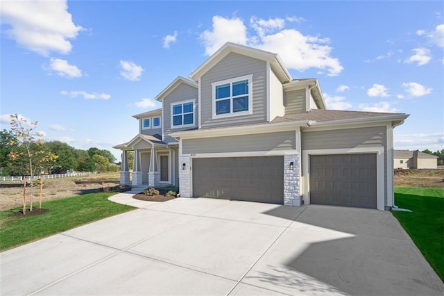 view of front of property featuring a front lawn and a garage