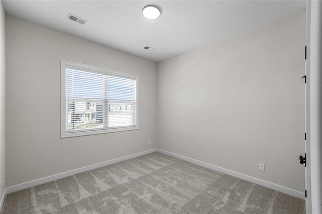 unfurnished room with light carpet