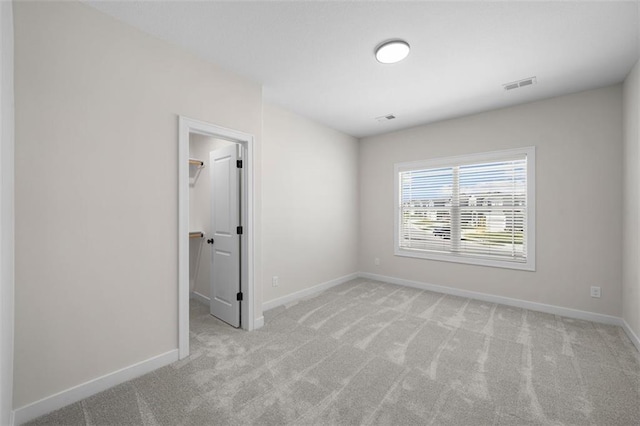 unfurnished room with light carpet
