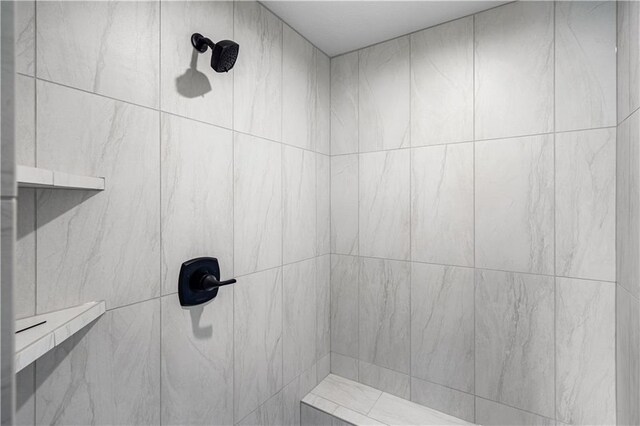 bathroom with a tile shower