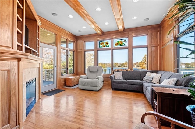 sunroom / solarium with a fireplace and beamed ceiling