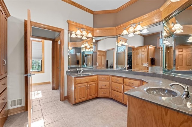 bathroom with tile patterned flooring, vanity, and ornamental molding