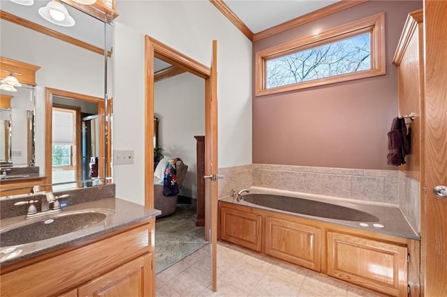 bathroom featuring a tub to relax in, a wealth of natural light, vanity, and ornamental molding