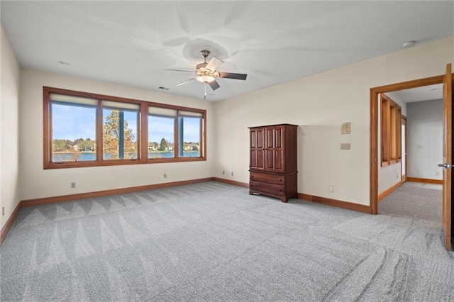 unfurnished room featuring ceiling fan and light carpet