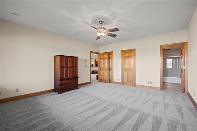 unfurnished bedroom with light carpet, connected bathroom, and ceiling fan