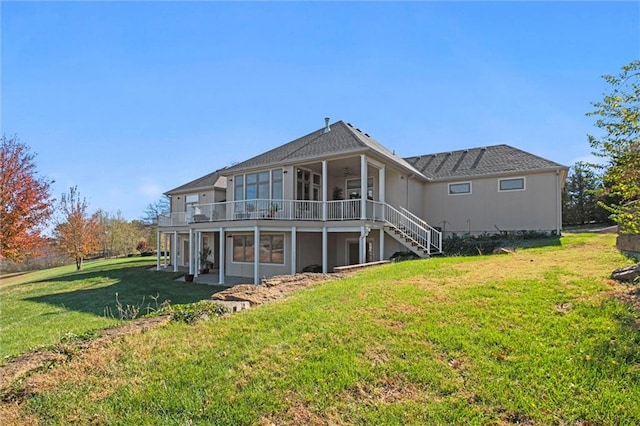 back of property featuring a yard and a sunroom