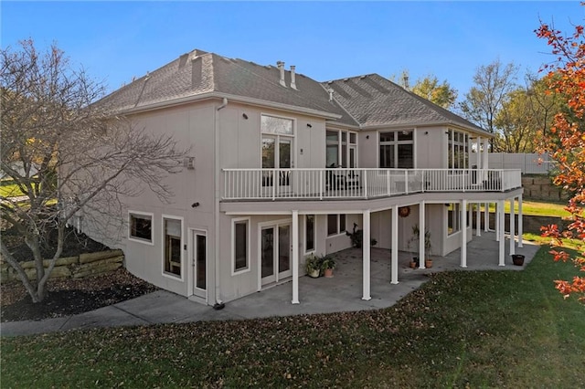 rear view of property with a patio area, a yard, and a deck