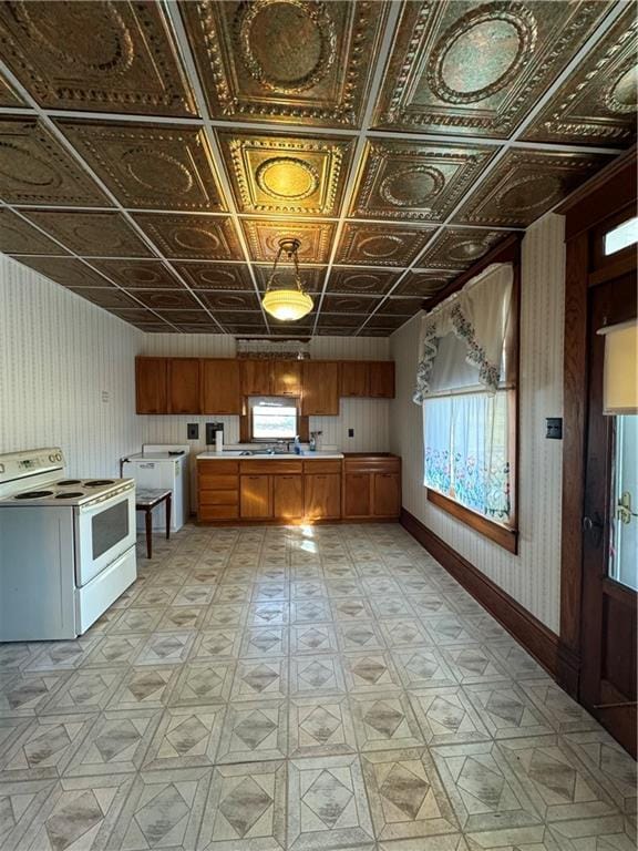 kitchen with washer / dryer and electric range