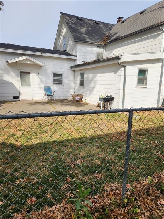 back of house with a lawn