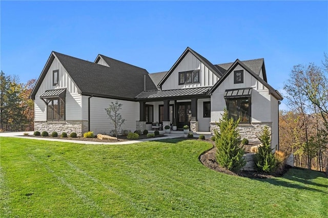 view of front of home with a front yard and covered porch