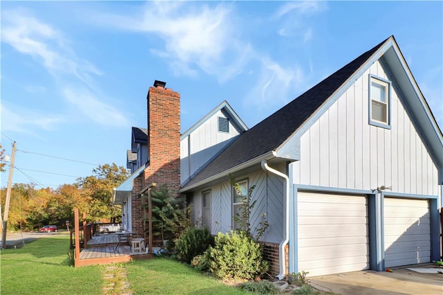 view of property exterior featuring a garage and a lawn